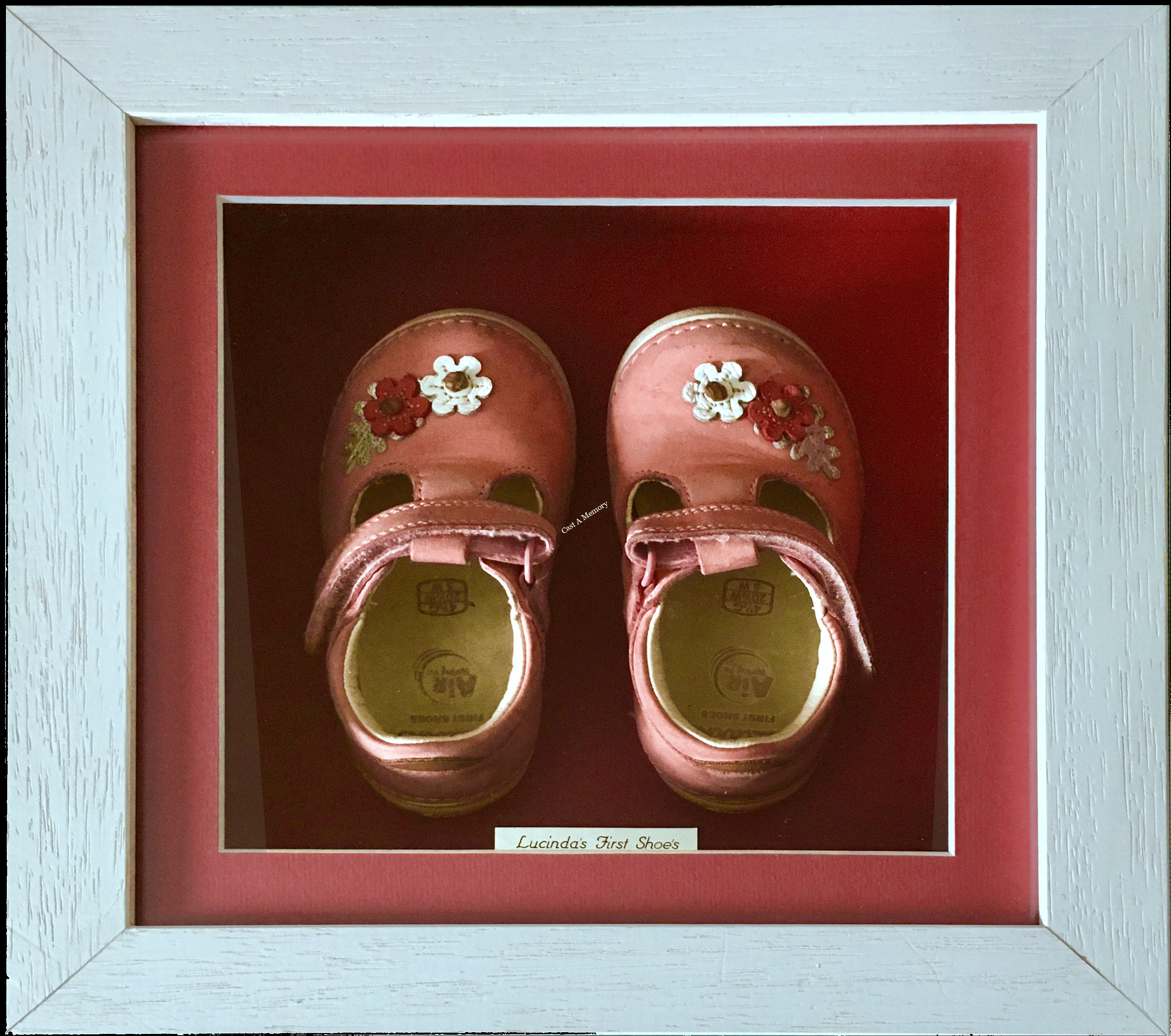 Baby's first pink shoes in wooden box frame