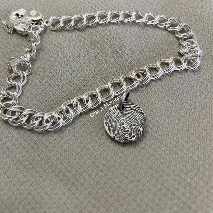tiny silver charm with fingerprint on bracelet