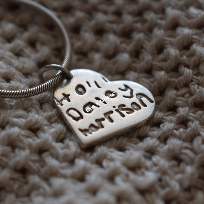 heart shaped silver charm with children names inscribed in