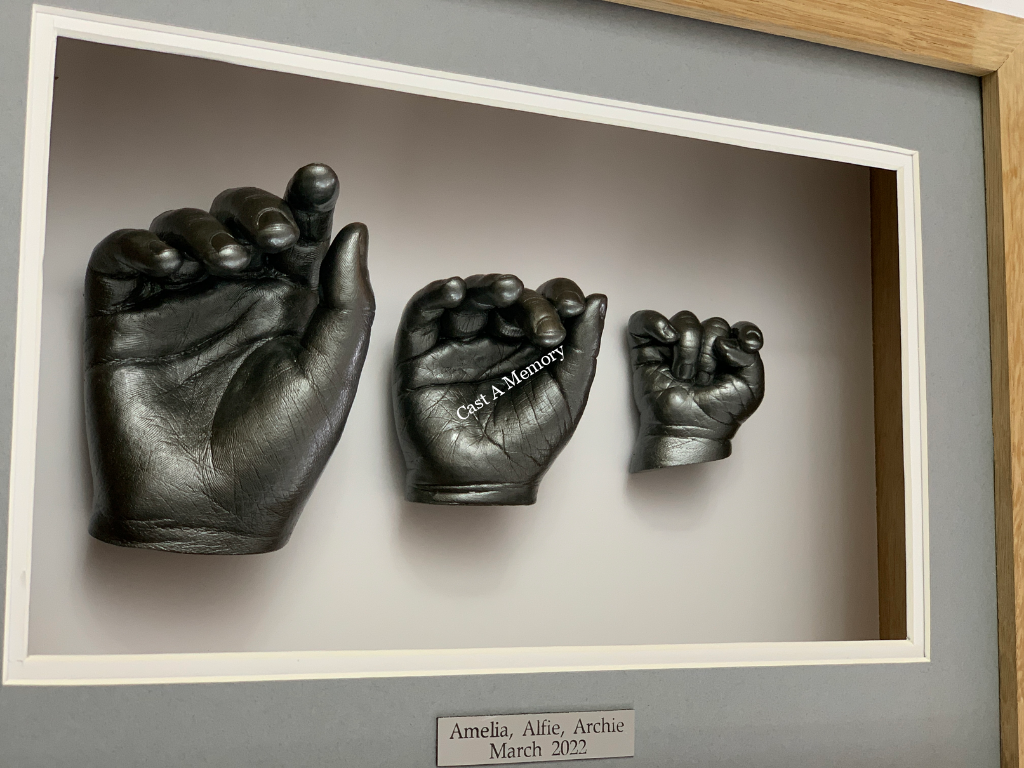 Three hand casts in frame