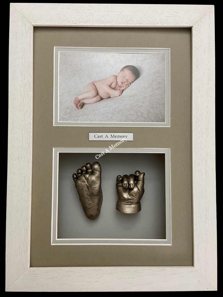 framed baby hand and foot cast with photo of sleeping baby