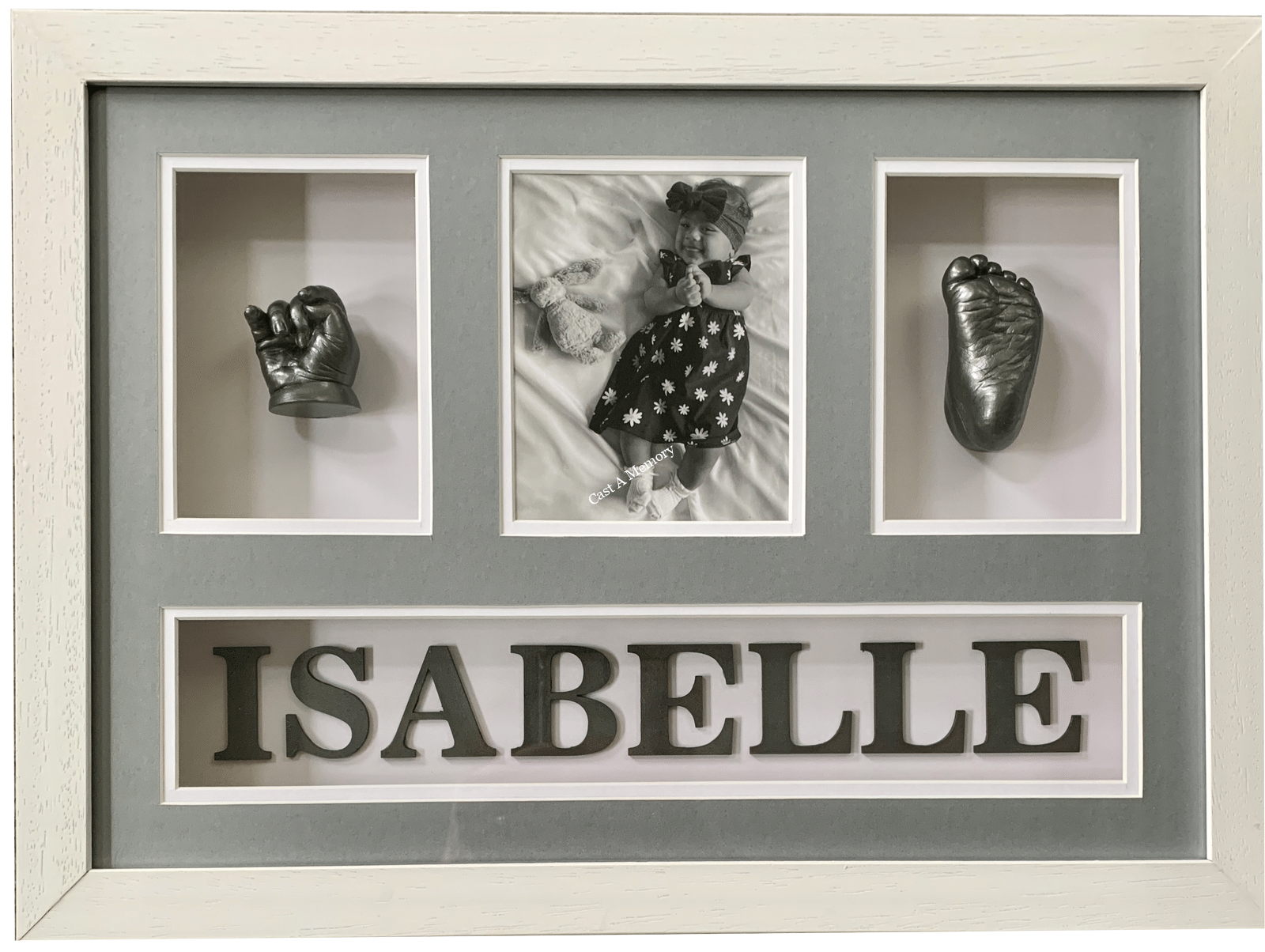 baby hand and foot cast in frame with black and white photo of child
