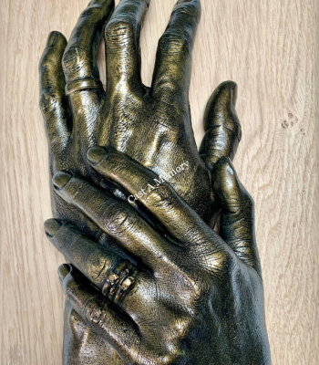 Two horizontal hand casts on wooden base