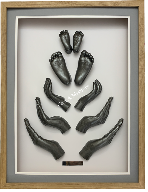 three sets of hands and two feet family life casts framed