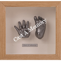 Baby hand and foot casting in a wooden frame
