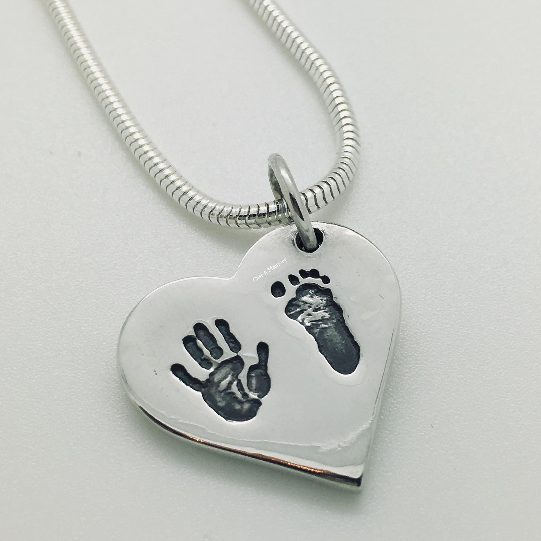 silver heart shaped personalised charm with baby hand and foot print