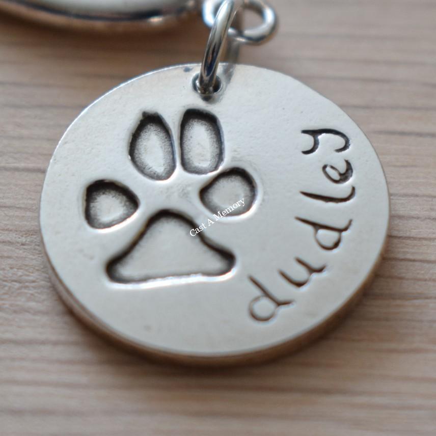 Large silver charm of dog paw print in silver